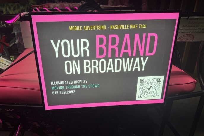 A backlit box for a movie poster mounted on a pedicab for outdoor advertising