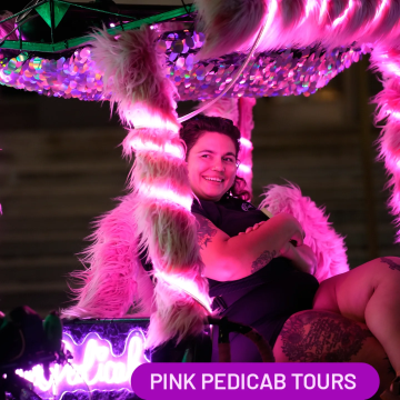 Girl on a pink neon furry glowing pedicab on Broadway in Nashville. 