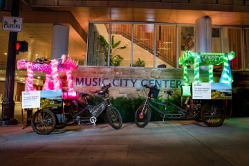 Pink and Green Neon Pedicabs at the Music City Center for a convention in Nashville.