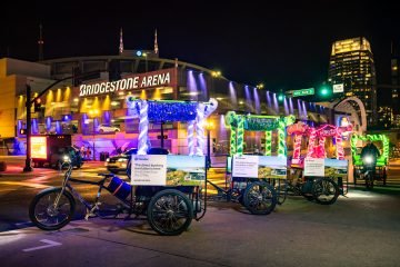 Neon furry pedicabs lined up in front of Bridgestone arena in Nashville, TN.